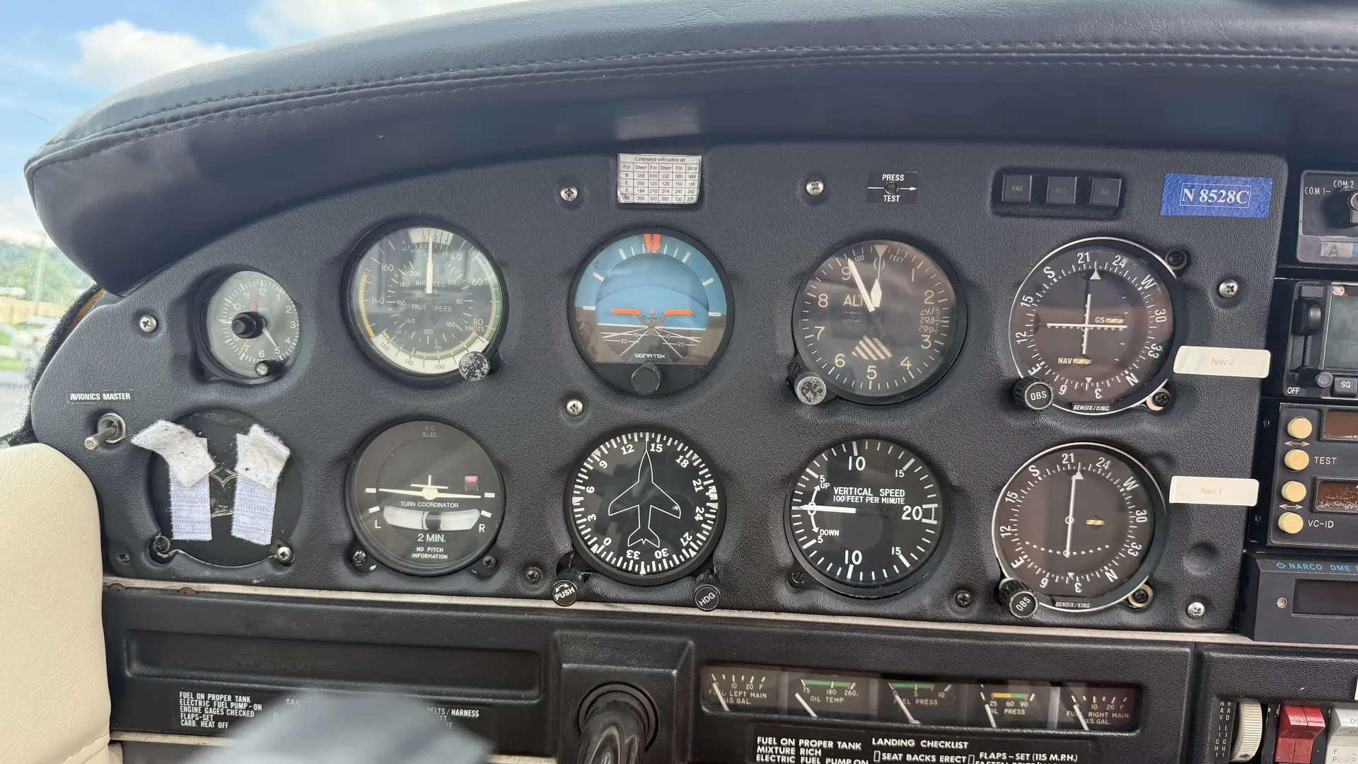 The six primary flight instruments arranged in the standard T on the pilot's side.