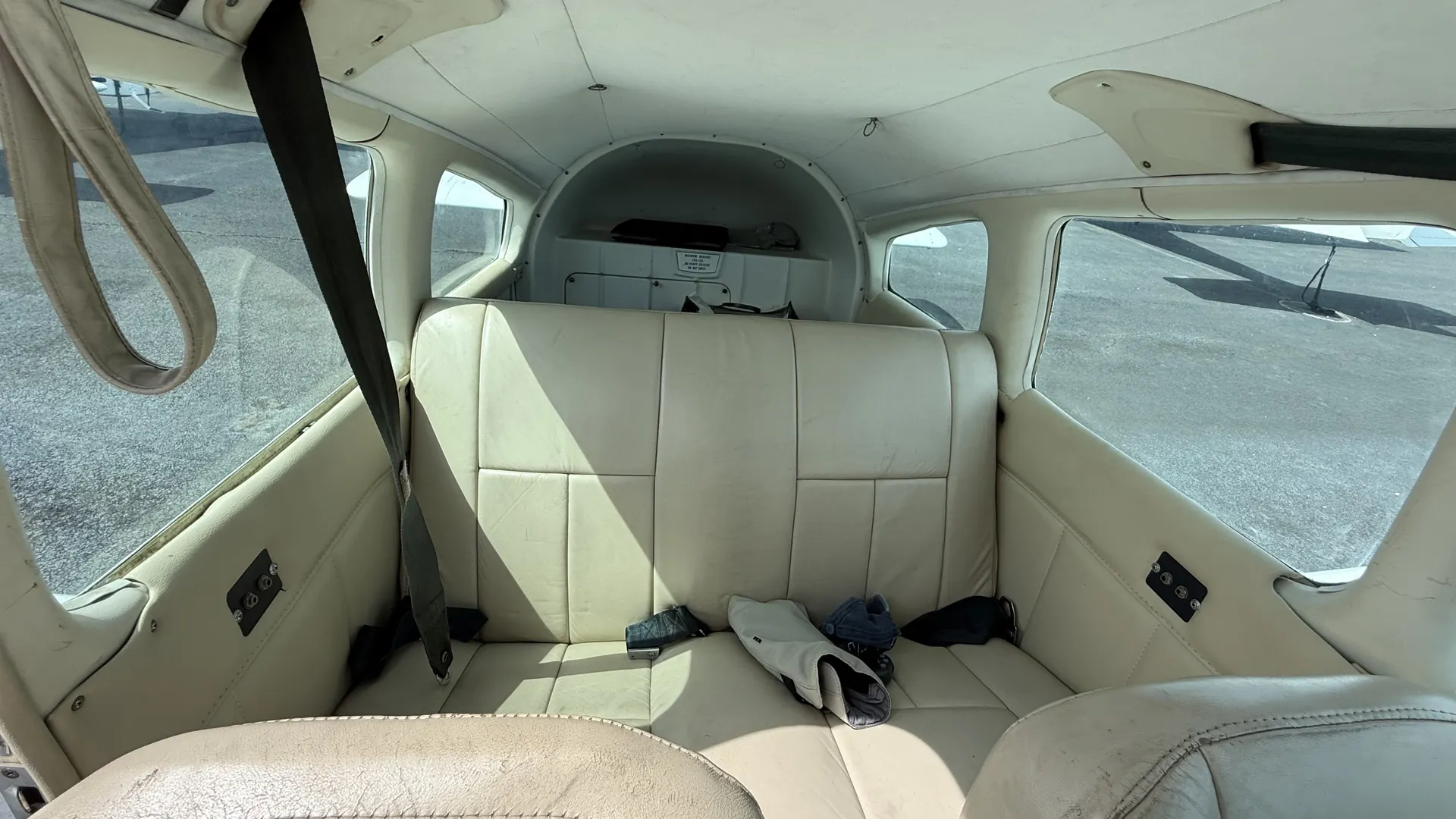 The rear bench seat of the Warrior with windows on both sides.